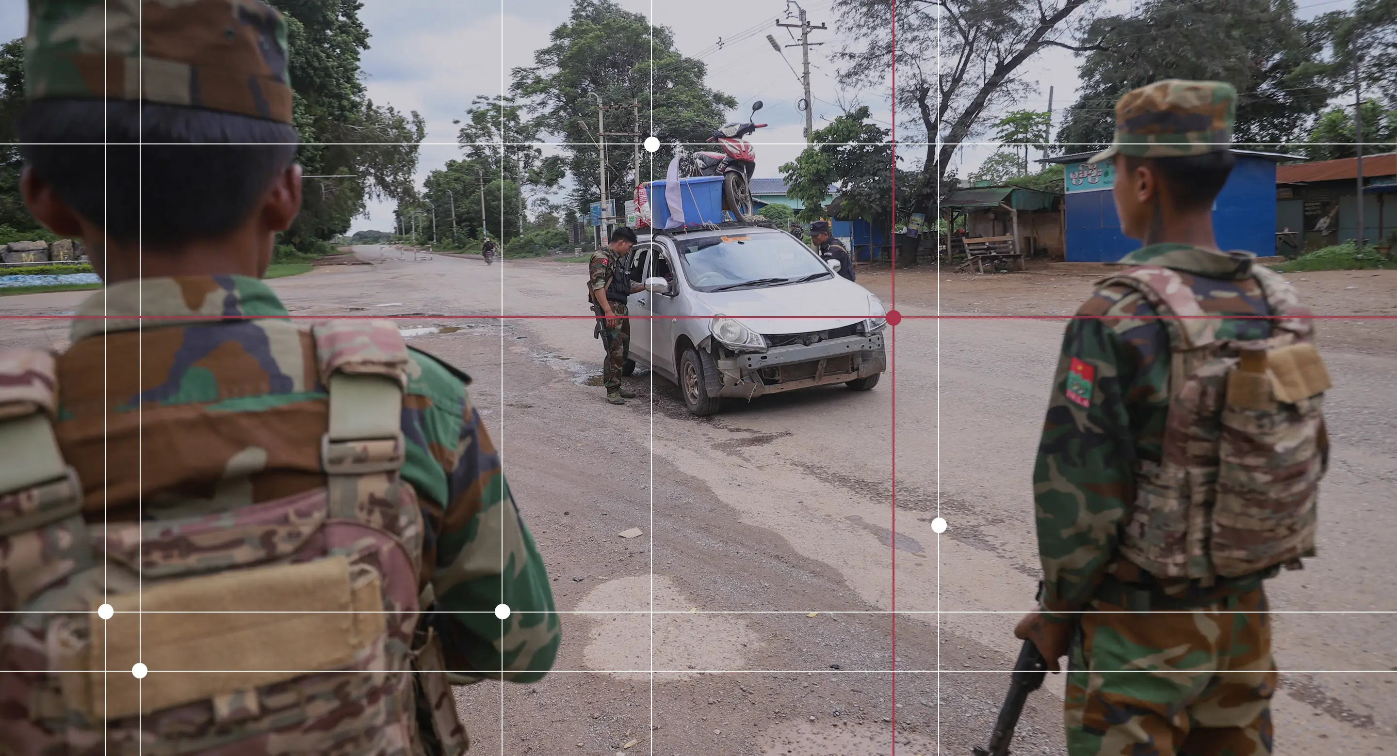 Members of the ethnic armed group Ta'ang National Liberation Army (TNLA) standing guard at a checkpoint in the town of Kyaukme in Myanmar's northern Shan State