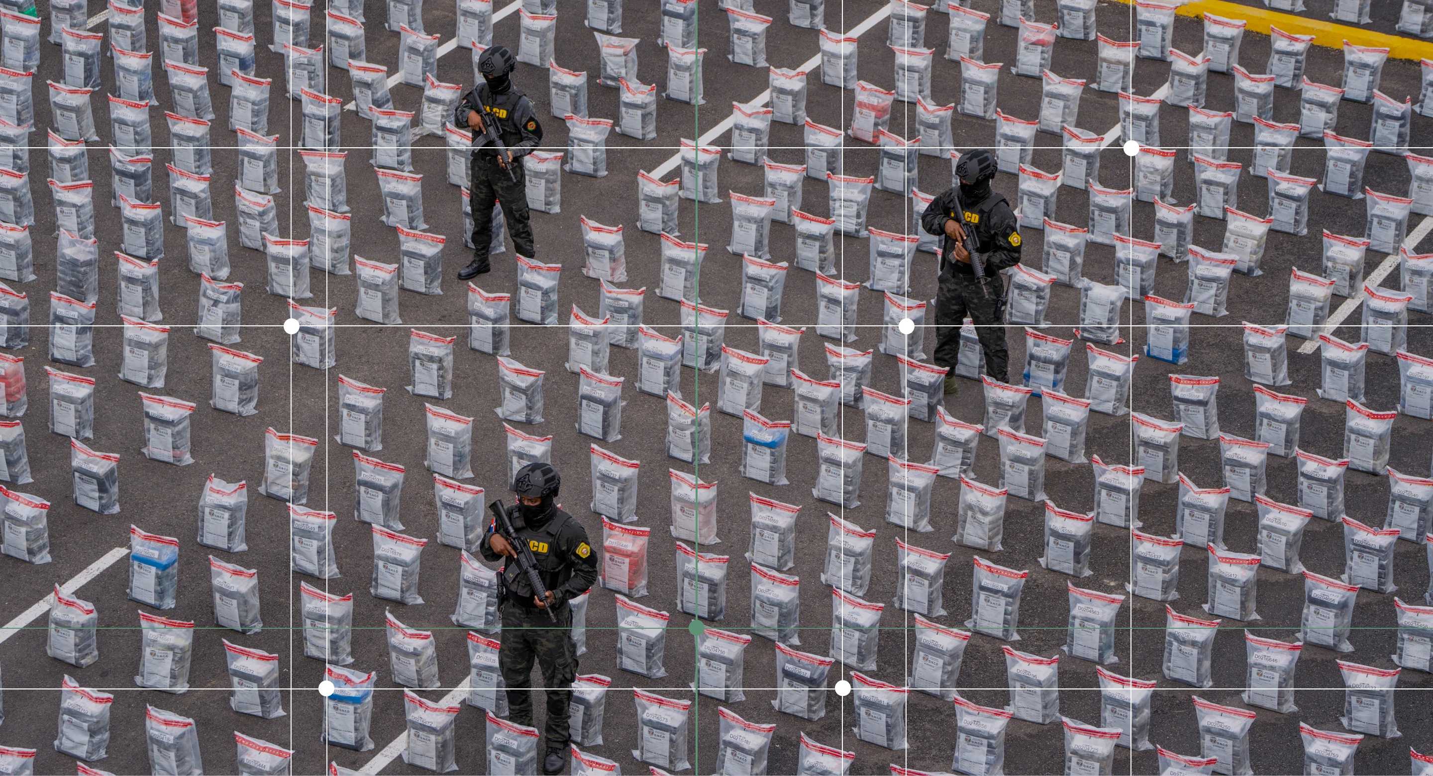 Anti-drug corps stand guard next to the packages of suspected drugs at the National Drug Control Directorate after a seizure of 9.5 tonnes of suspected cocaine in Santo Domingo.