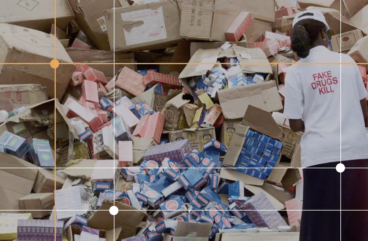 An official of the National Agency for Food and Drug Administration and Control (NAFDAC) off-loading cartoons of fake drugs for destruction